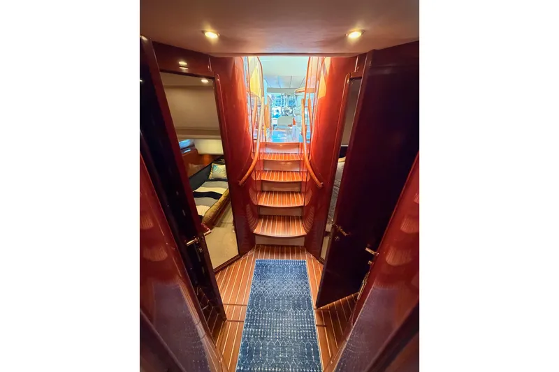 Slide: The Image of Interior view of 2001 Fairline 55 yacht with wooden stairs and cozy cabin. - 125