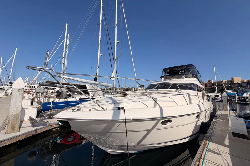 Slide: The Image of 2001 Fairline 55 yacht docked at marina under clear blue sky. - 4