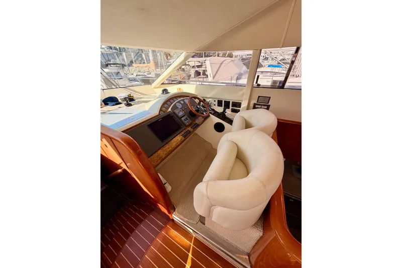 Slide: The Image of Luxurious helm of 2001 Fairline 55 yacht with plush seating and modern controls. - 81