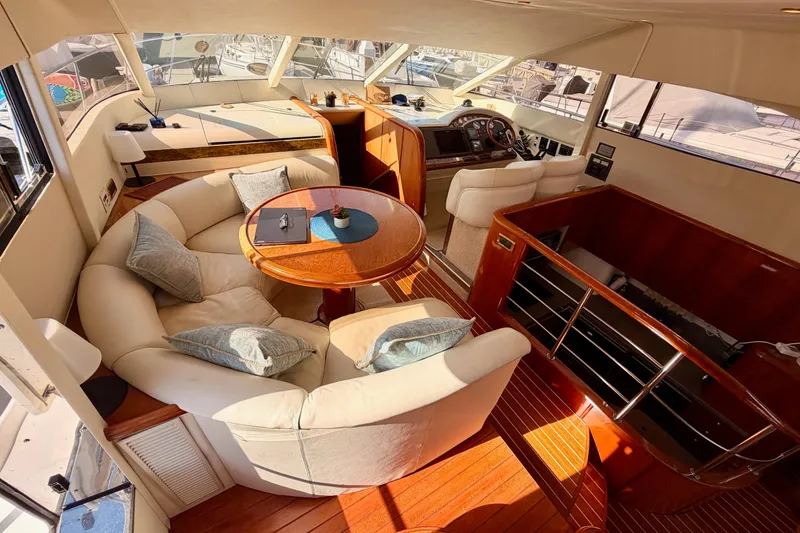 Slide: The Image of Luxurious interior of a 2001 Fairline 55 yacht with elegant seating and helm. - 79