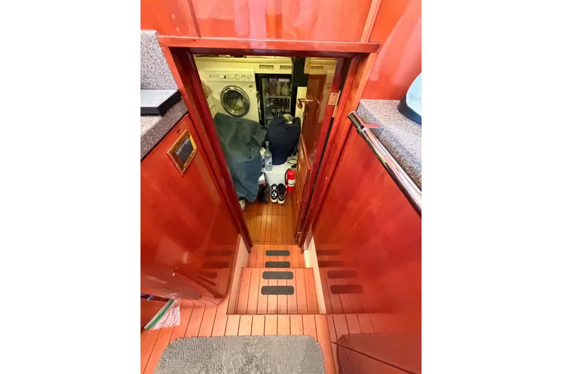 Slide: The Image of Interior view of 2001 Fairline 55 yacht showing laundry area and wooden flooring. - 33
