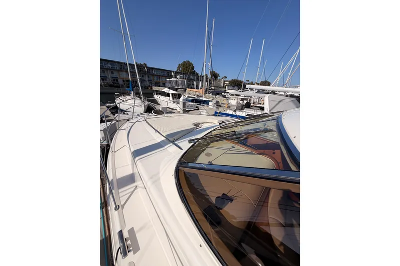 Slide: The Image of 2001 Fairline 55 yacht docked in a marina under clear blue skies. - 49