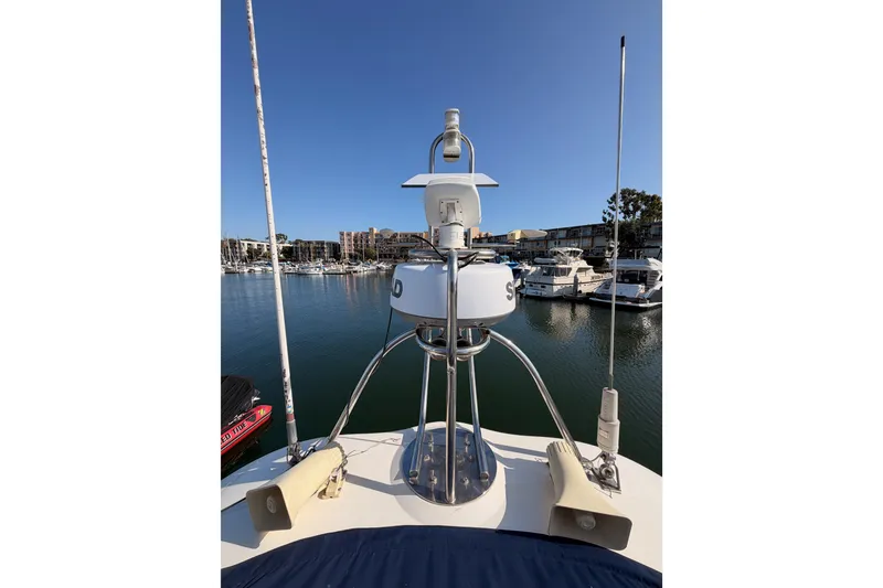 Slide: The Image of Radar and antennas on 2001 Fairline 55 yacht, docked in a marina. - 63