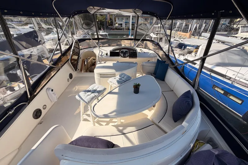Slide: The Image of Luxurious 2001 Fairline 55 yacht interior with elegant seating and marina view. - 64