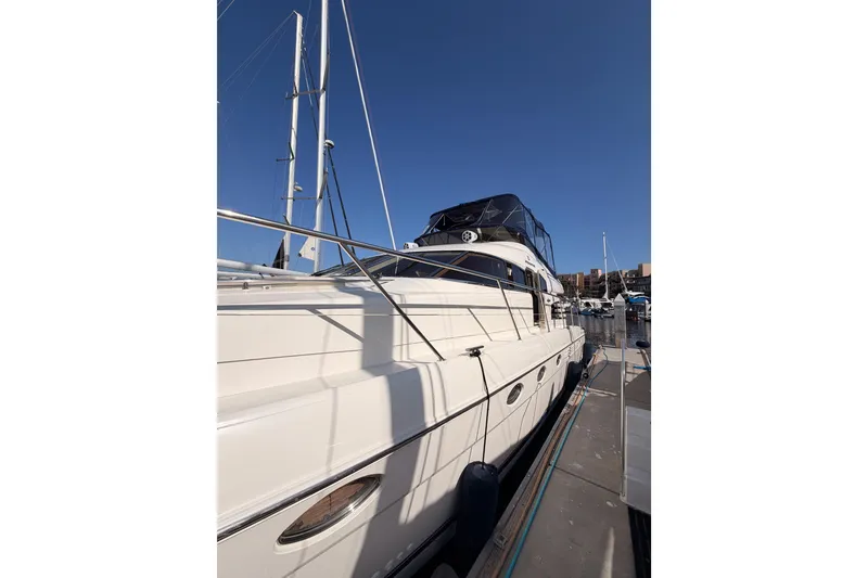 Slide: The Image of 2001 Fairline 55 yacht docked at marina under clear blue sky. - 5