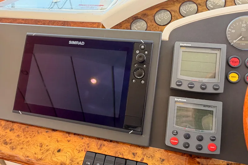 Slide: The Image of Control panel of a 2001 Fairline 55 yacht with Simrad and Raytheon displays. - 89