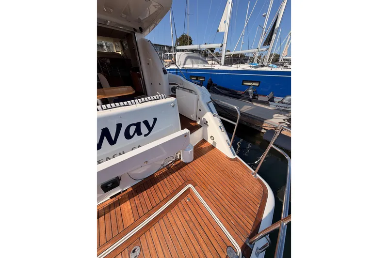 Slide: The Image of 2001 Fairline 55 yacht with teak deck, docked beside a blue sailboat. - 13