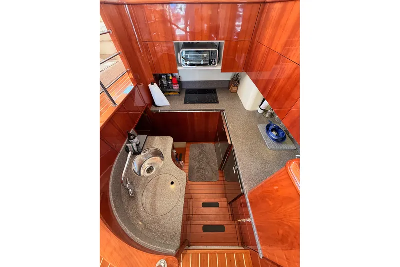 Slide: The Image of Luxurious 2001 Fairline 55 yacht kitchen with sleek wood cabinetry and modern appliances. - 28