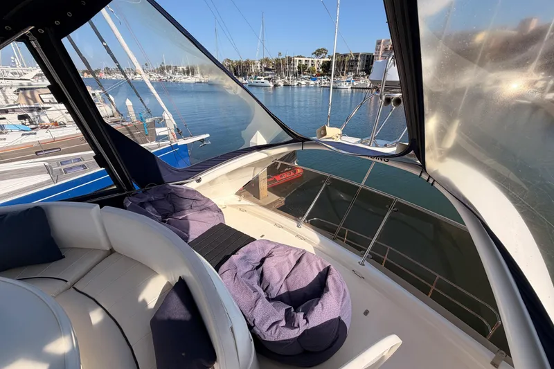 Slide: The Image of Luxurious 2001 Fairline 55 yacht interior with marina view and comfortable seating. - 62