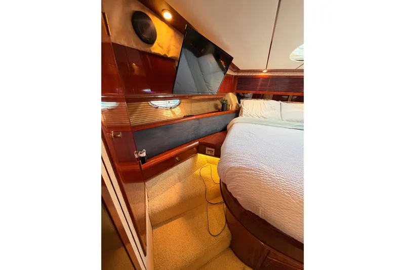 Slide: The Image of Luxurious cabin interior of 2001 Fairline 55 yacht with elegant wood finishes. - 116