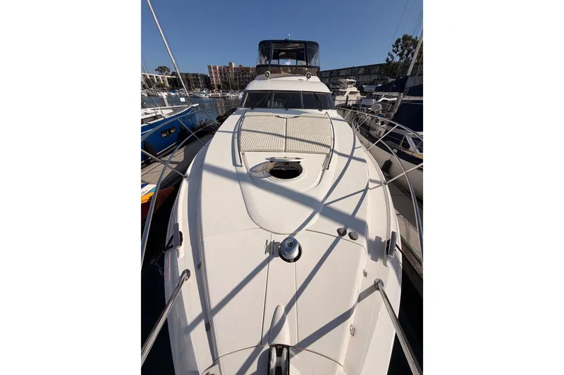 Slide: The Image of Front view of a 2001 Fairline 55 yacht docked at a marina. - 54