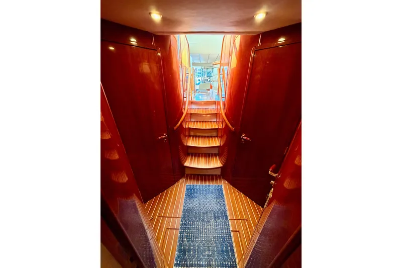 Slide: The Image of Interior view of 2001 Fairline 55 yacht with polished wood and carpeted stairs. - 95