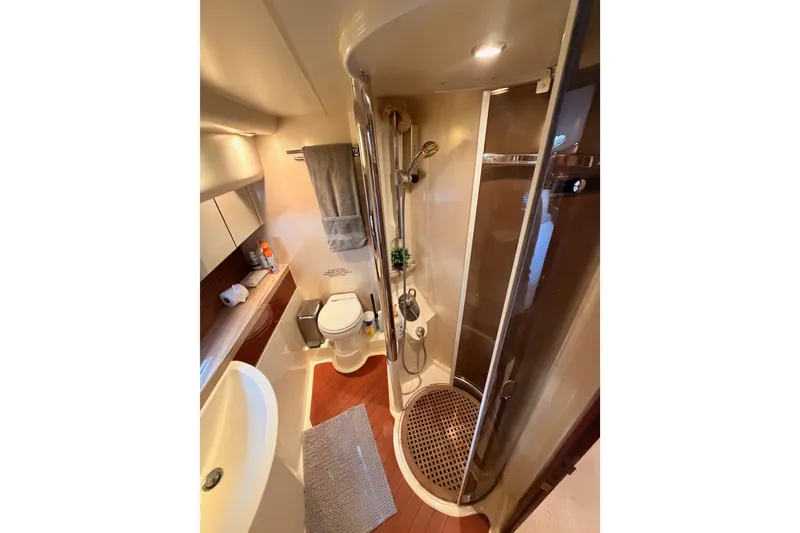 Slide: The Image of Luxurious bathroom in a 2001 Fairline 55 yacht, featuring a modern shower and elegant fixtures. - 121