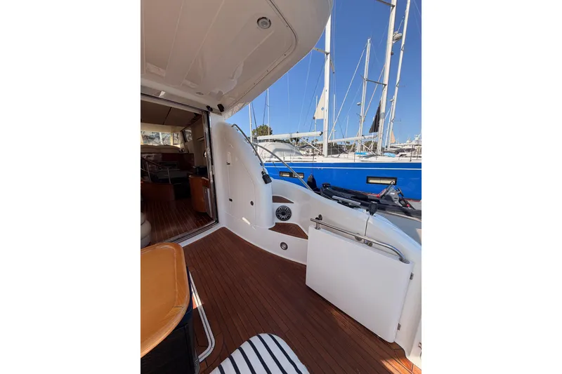 Slide: The Image of 2001 Fairline 55 yacht interior with wooden deck, docked at marina. - 16