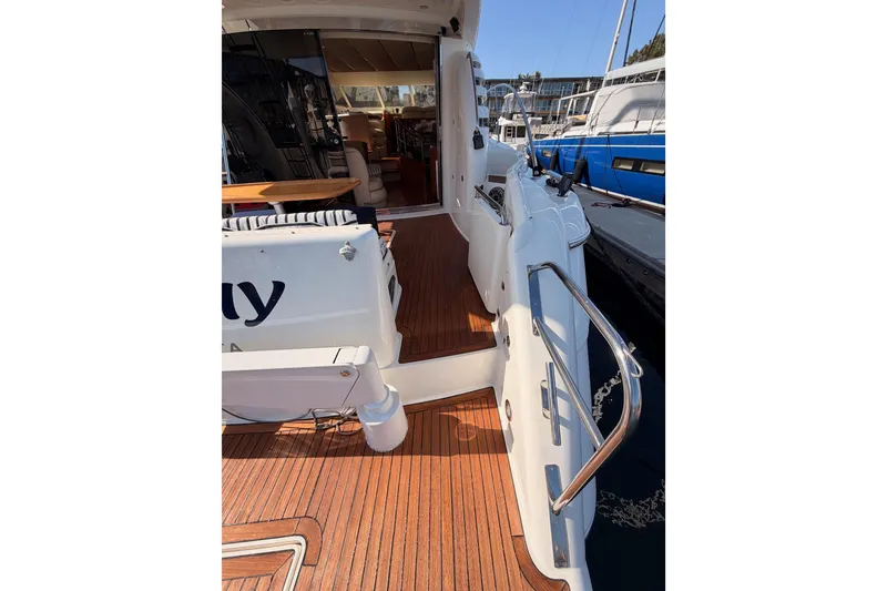 Slide: The Image of Luxury Fairline 55 yacht, 2001 model, featuring elegant teak decking and spacious interior. - 17
