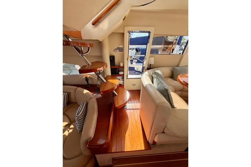 Slide: The Image of Luxurious interior of 2001 Fairline 55 yacht with elegant wood and leather furnishings. - 46