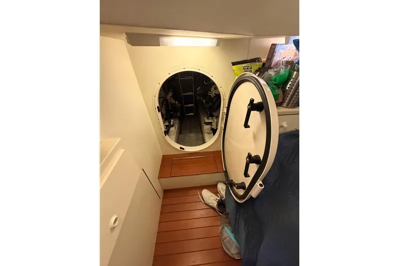 Slide: The Image of Engine room access hatch on 2001 Fairline 55 yacht, featuring wooden flooring and storage. - 36
