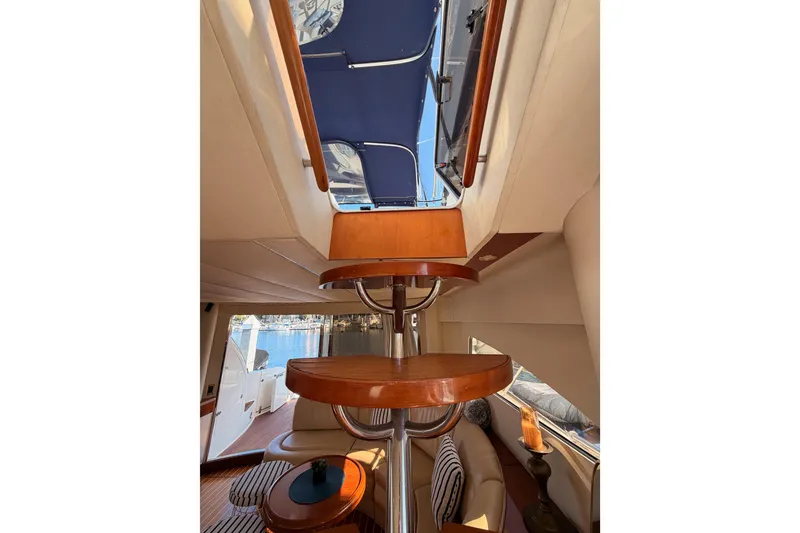 Slide: The Image of Interior view of 2001 Fairline 55 yacht, featuring elegant wooden staircase and luxurious seating. - 59