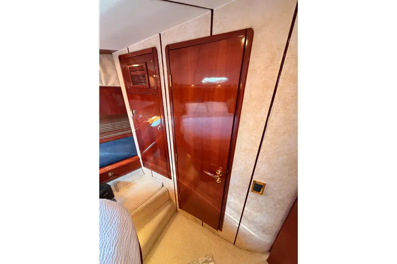 Slide: The Image of Luxurious wooden interior of 2001 Fairline 55 yacht cabin, featuring elegant doors and plush carpeting. - 119