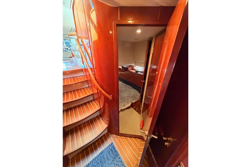 Slide: The Image of Interior view of 2001 Fairline 55 yacht, featuring wooden stairs and cozy cabin entrance. - 106