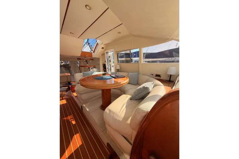 Slide: The Image of Luxurious interior of a 2001 Fairline 55 yacht with elegant seating and wooden accents. - 128
