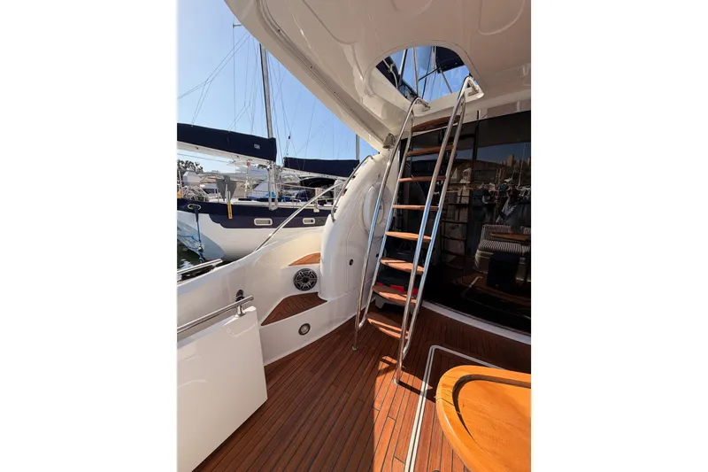 Slide: The Image of Interior view of 2001 Fairline 55 yacht with wooden deck and metal ladder. - 15
