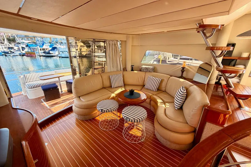 Slide: The Image of Luxurious interior of a 2001 Fairline 55 yacht with elegant seating and marina view. - 44
