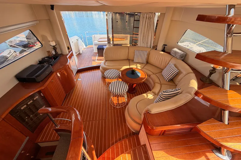 Slide: The Image of Luxurious interior of 2001 Fairline 55 yacht with elegant wood finishes and plush seating. - 132