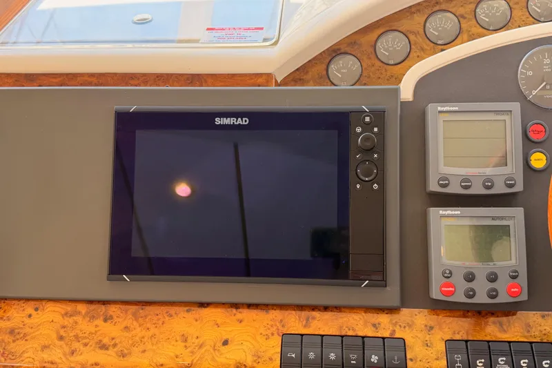 Slide: The Image of Control panel of a 2001 Fairline 55 yacht with Simrad and Raytheon displays. - 83