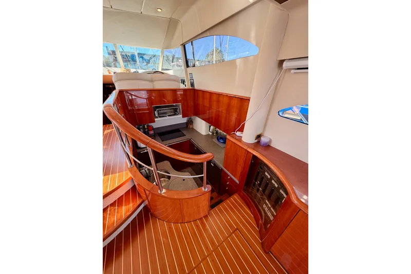 Slide: The Image of Interior of 2001 Fairline 55 yacht with polished wood and modern design elements. - 26