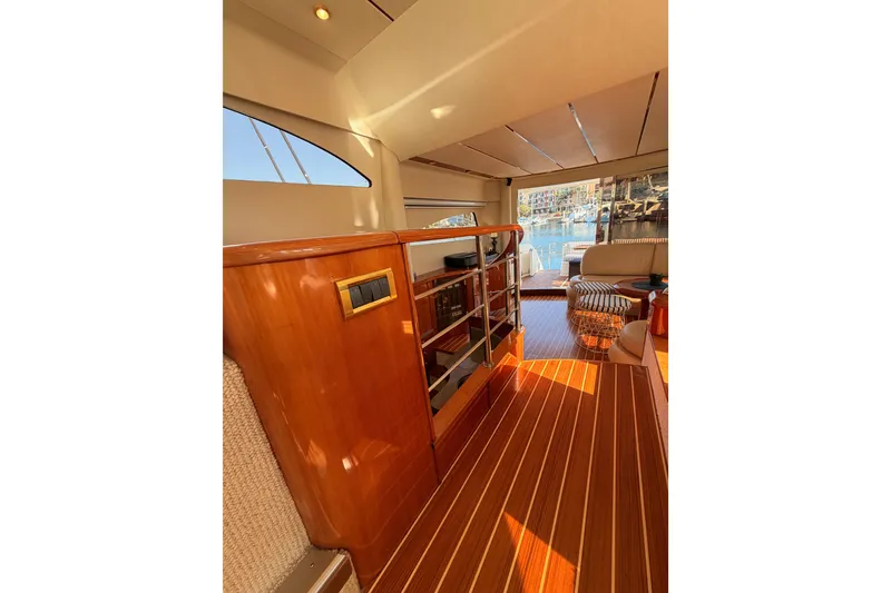 Slide: The Image of Luxurious interior of 2001 Fairline 55 yacht with wooden flooring and elegant seating. - 131
