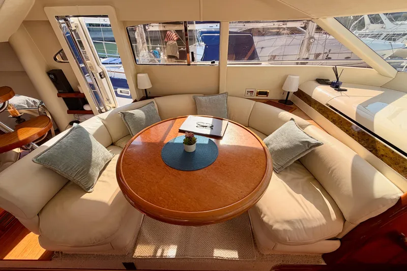 Slide: The Image of Luxurious interior of a 2001 Fairline 55 yacht with elegant seating and wooden table. - 80