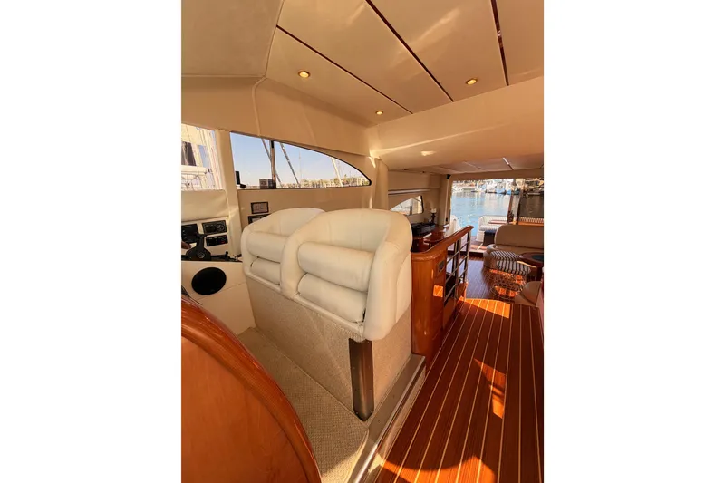 Slide: The Image of Interior of 2001 Fairline 55 yacht with elegant seating and wooden flooring. - 129