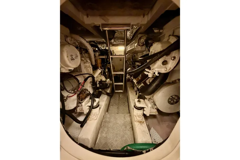 Slide: The Image of Engine room of a 2001 Fairline 55 yacht, showcasing mechanical components and piping. - 37