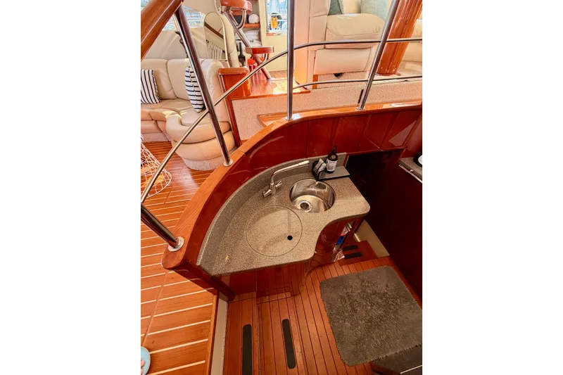 Slide: The Image of Luxurious interior of 2001 Fairline 55 yacht with elegant wood finish and compact sink area. - 30