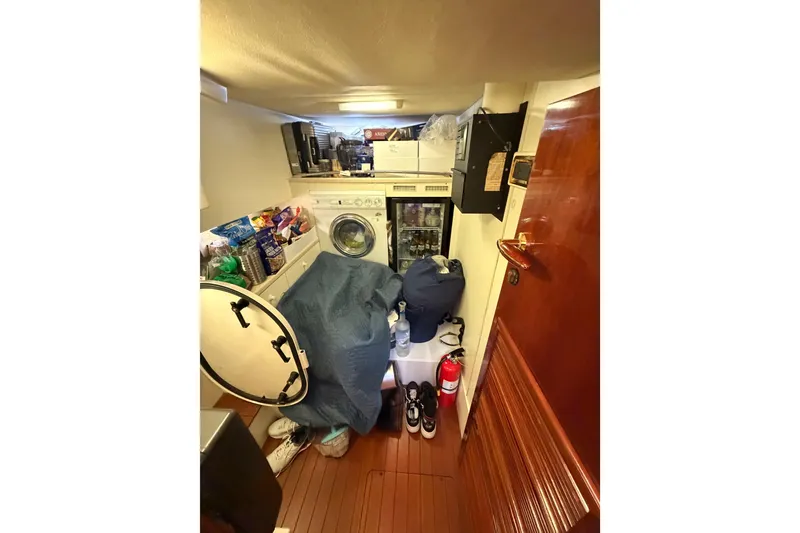 Slide: The Image of Laundry area on 2001 Fairline 55 yacht with washing machine and storage. - 34