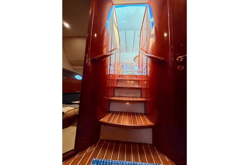Slide: The Image of Staircase inside 2001 Fairline 55 yacht with polished wood finish and elegant design. - 126