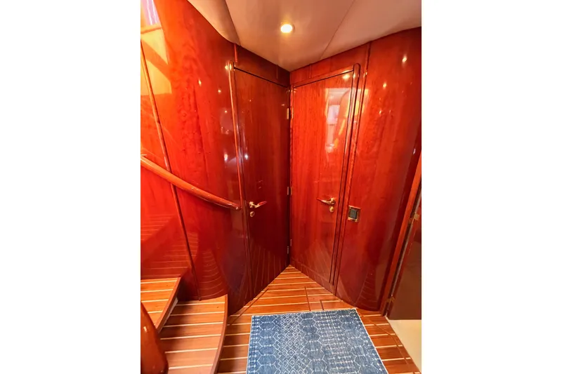 Slide: The Image of Luxurious wooden interior of 2001 Fairline 55 yacht with elegant staircase and blue rug. - 101