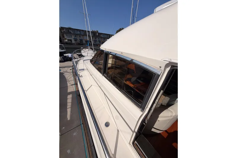 Slide: The Image of 2001 Fairline 55 yacht side view, showcasing sleek design and spacious deck area. - 48
