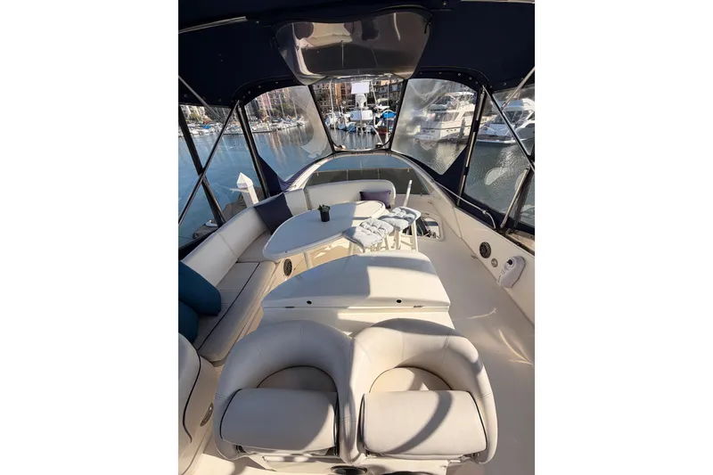 Slide: The Image of Luxurious interior of a 2001 Fairline 55 yacht with comfortable seating and marina view. - 76