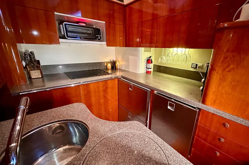 Slide: The Image of Luxurious kitchen interior of 2001 Fairline 55 yacht with modern appliances and wood finish. - 146