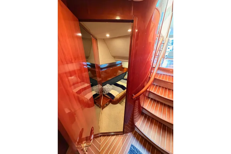 Slide: The Image of Interior of 2001 Fairline 55 yacht, featuring wooden stairs and cozy cabin entrance. - 96