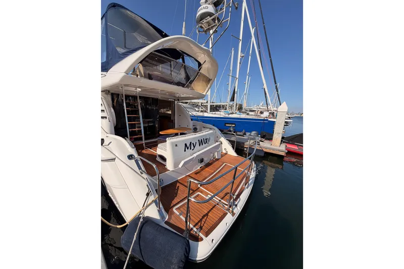 Slide: The Image of Luxury 2001 Fairline 55 yacht docked at marina, showcasing elegant design and spacious deck. - 9