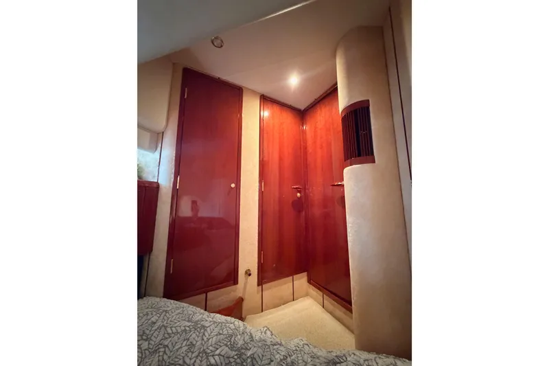 Slide: The Image of Luxurious interior of 2001 Fairline 55 yacht with wooden cabinetry and soft lighting. - 111