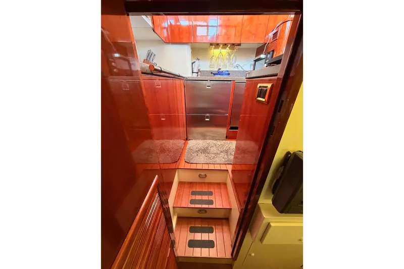 Slide: The Image of Interior view of 2001 Fairline 55 yacht kitchen with wooden cabinetry and modern appliances. - 38