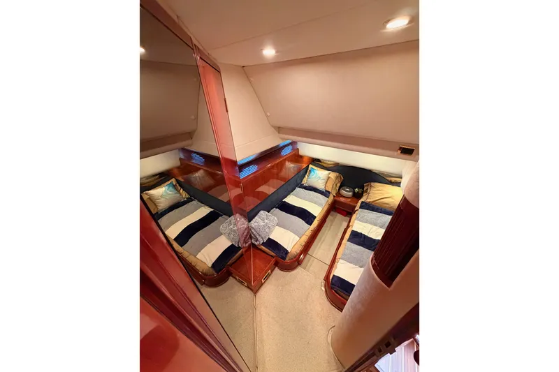 Slide: The Image of Luxurious twin cabin interior of 2001 Fairline 55 yacht with striped bedding. - 97