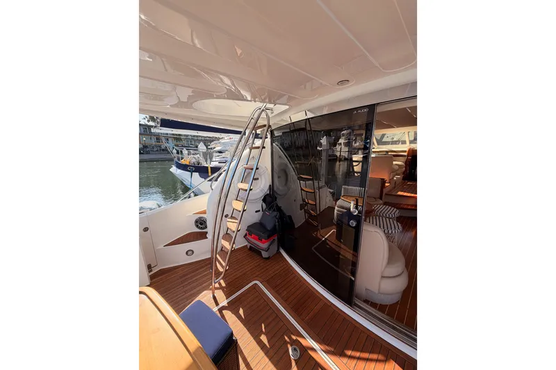 Slide: The Image of Interior view of 2001 Fairline 55 yacht with elegant wooden flooring and seating. - 19