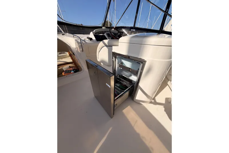 Slide: The Image of Open fridge on 2001 Fairline 55 yacht deck, showcasing interior storage space. - 69