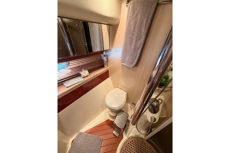 Slide: The Image of Luxurious bathroom in a 2001 Fairline 55 yacht, featuring modern fixtures and elegant design. - 104