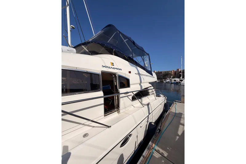 Slide: The Image of Luxury Fairline 55 yacht from 2001 docked at marina under clear blue sky. - 6